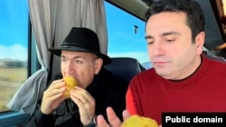 Armenia - Prime Minister Nikol Pashinian and parliament speaker Alen Simonian eat during an election campaign trip, March 21, 2026.