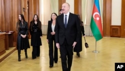Azerbaijani leader Ilham Aliyev (center) and his family arrive in Nagorno-Karabakh to vote in a presidential election on February 7.