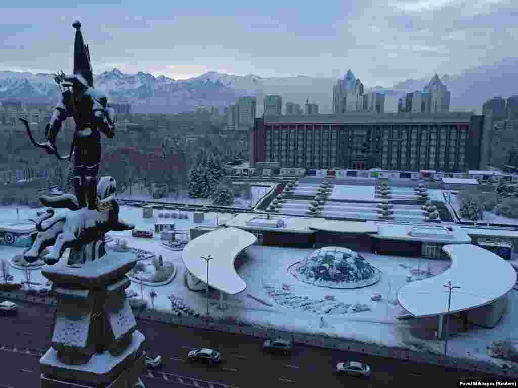 A Kazakh independence monument is covered in snow in front of the city administration headquarters in Almaty.&nbsp;
