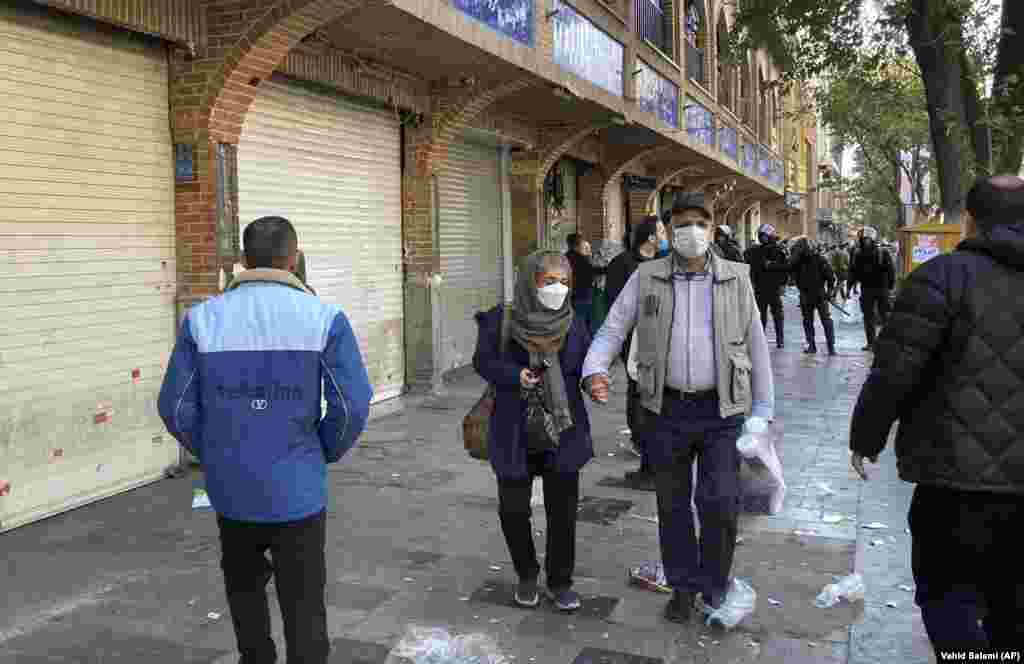 Iranian police in riot gear are seen on a street next to the closed shops of Tehran&#39;s Grand Bazaar on November 15.&nbsp; At least 330 people have died in the current unrest across Iran, including two protesters who were shot dead on November 15. That night, videos from Tehran showed protesters blocking a traffic circle while honking car horns and chanting, &quot;Freedom!&quot;&nbsp;