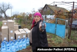 Tatyana Derkach shows the mobile phone she used to pass information on Russian troops to the Ukrainian side.