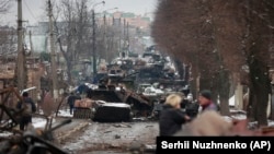 The gutted remains of Russian military vehicles on a road in the town of Bucha, close to the capital, Kyiv, on March 1.