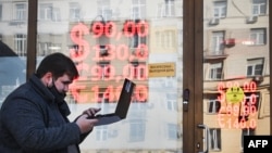 RUSSIA -- A man walks past a currency exchange office in central Moscow on February 28, 2022.