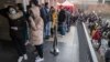 Ukrainian refugees stand in line to file for residence permits at the headquarters of Prague's foreigner's police on March 2.