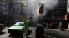 A city worker disinfects a bus stop sign because of the new coronavirus in Tehran, March 5, 2020