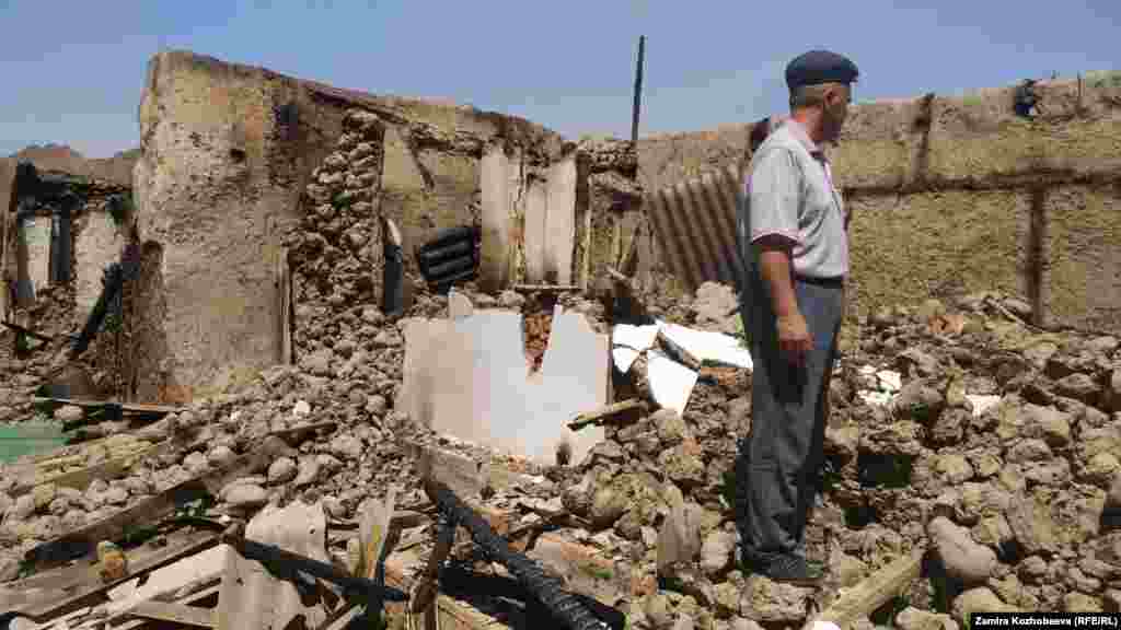 Мужчина на руинах своего дома в Баткенской области Кыргызстана, разрушенного во время смертоносных вооруженных столкновений на кыргызско-таджикской границе. 4 мая&nbsp;