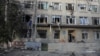 A man stands at the entrance to a building in Odesa that was damaged by a drone strike on February 8. 