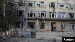 A man stands at the entrance to a building in Odesa that was damaged by a drone strike on February 8. 