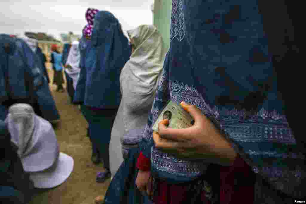 Afghan women wait to vote at a polling station in Mazar-i-Sharif on April 5. The presidential election, marking the first democratic transfer of power since the fall of the Taliban regime, led to a run-off vote that brought Ashraf Ghani to power. (Zohra Bensemra, Reuters)