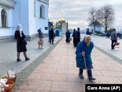 Starija žena prolazi blagoslov pravoslavnih uskrsnih košara ispred vjerskog kompleksa Kijevsko-pečerske lavre u Kijevu, Ukrajina, u nedjelju, 24. aprila 2022.