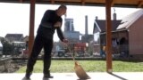 Serbia, Veliki Crljeni -- Radisav Jovanovic cleans the dust from coal power plant, which is 250m far from his house, February 18 2022