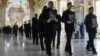 Men carry portraits of (from right) Valeria Hlodan and her mother, Lyudmyla Yavkina, who were killed in their apartment by Russian shelling along with 3-month-old infant Kira Hlodan during a funeral ceremony in Odesa on April 27, 2022.