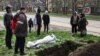 A funeral for a local resident killed in Russian shelling is held on a street in Mariupol on April 19.