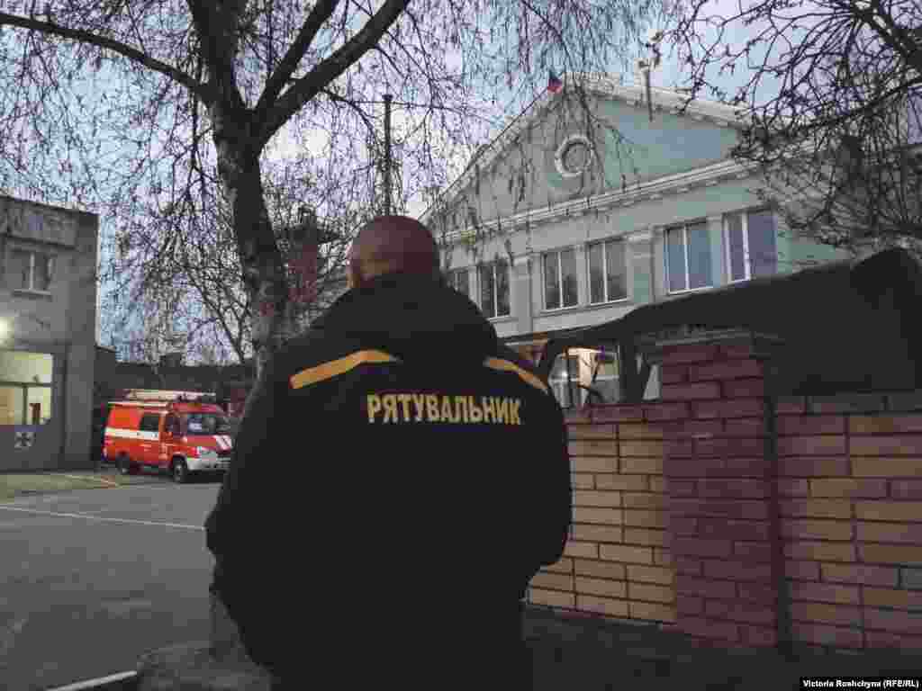 A rescue worker in occupied Nova Kakhovka walks toward the State Emergency building where a Russian flag now flies. While some rescue workers left when the occupation began, others remained to assist their fellow citizens. &quot;As for the fact that the government abandoned Kherson, this is just an insult,&quot; said a local volunteer. &quot;There is no feeling yet that we will be liberated.&quot;