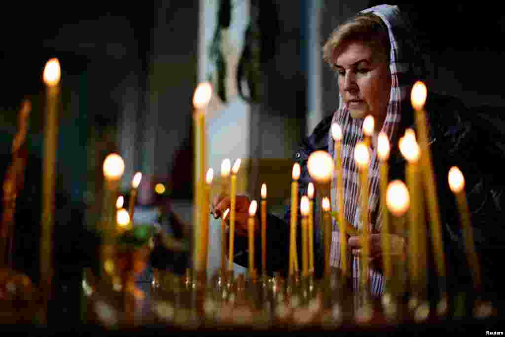 A Ukrainian woman takes part in Easter Mass at the Ukrainian Orthodox Cathedral of the Holy Trinity in Zaporizhzhya.