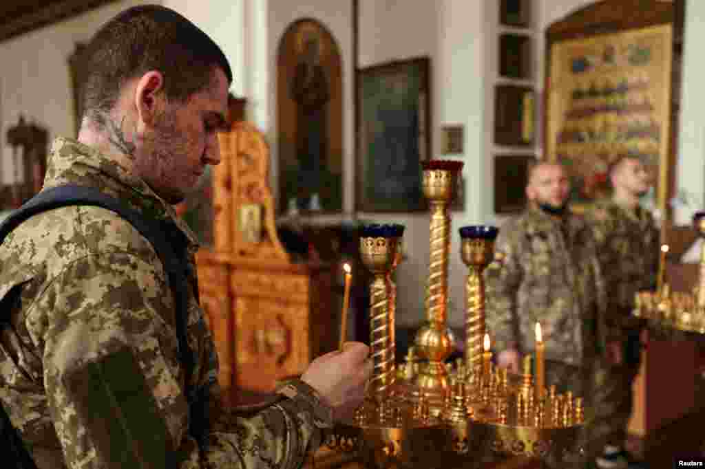 Ukrainian soldiers pray inside an Orthodox church during Easter in Slovyansk, near the front line in the eastern Donetsk region, on April 24.