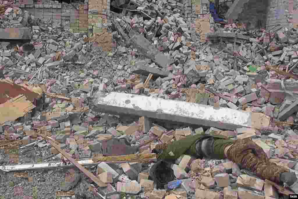 The body of a dead Ukrainian fighter lies amid rubble at an unnamed location in a picture released on April 27.&nbsp;