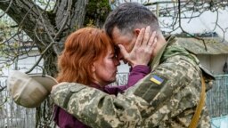 A woman says goodbye to her serviceman husband before he leaves for the front lines in Uzhhorod on April 26.