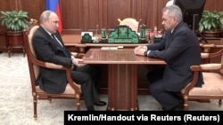 Russian President Vladimir Putin (left) attends a meeting with Defense Minister Sergei Shoigu in Moscow weeks after he ordered his country's troops to invade Ukraine, a move that Iver Neumann says could precipitate the end of the current Kremlin regime. 