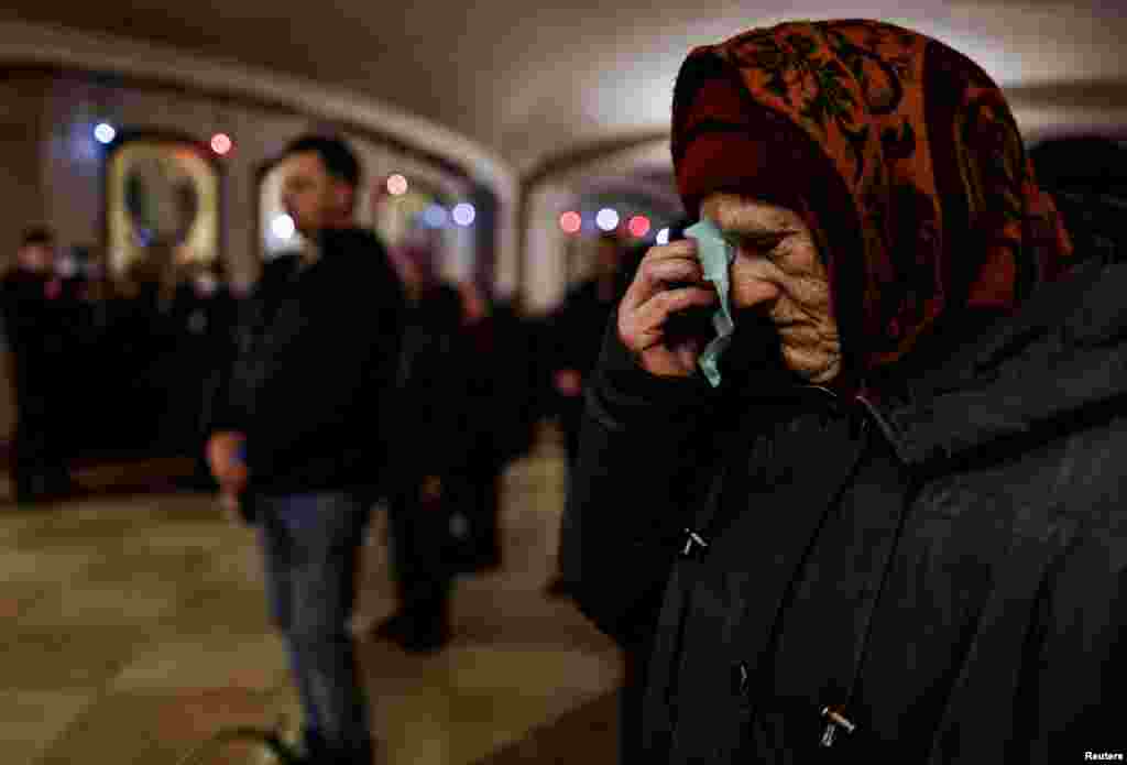 A woman wipes away tears as she attends Easter Mass at St. Andrew&#39;s Church and Pyervozvannoho All Saints in Bucha, outside Kyiv.