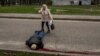 A woman next to the body of a man killed during Russian shelling in a residential area in Kharkiv on April 19. 