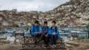 AFGHANISTAN -- School boys chat amongst themselves as they visit the Kart-e-Sakhi cemetery in Kabul on April 24, 2022. 