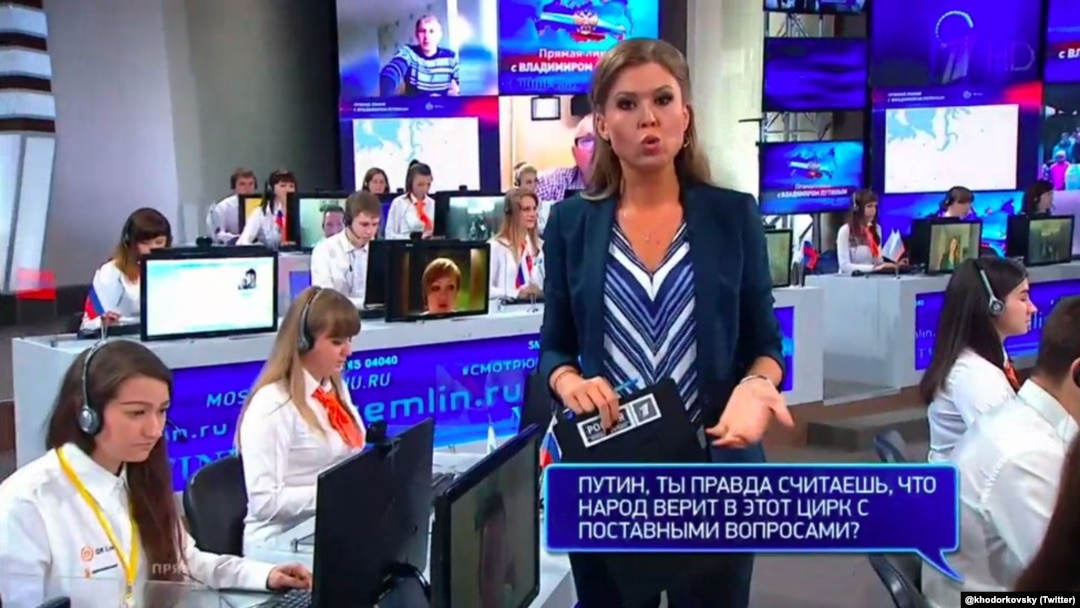 One on-screen question: "Putin, you really think that people believe this circus, with planted questions?" 