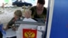 A woman casts her ballot at a mobile polling station during local elections organized by the Russian-installed authorities in Donetsk, Russian-controlled Ukraine, on September 6, 2023.