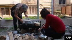 Nagorno-Karabakh - Local residents cook food in a street in Stepanakert, September 22, 2023.
