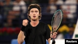 Andrei Rublev celebrates winning his semifinal match against Germany's Alexander Zverev in Dubai on March 3.