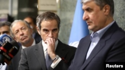 IAEA Director-General Rafael Mariano Grossi looks on during a news conference with the head of Iran's Atomic Energy Organization, Mohammad Eslami, as they meet in Tehran on March 5.