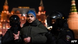 Police detain a man during a protest against Russia's invasion of Ukraine in central Moscow on March 2.