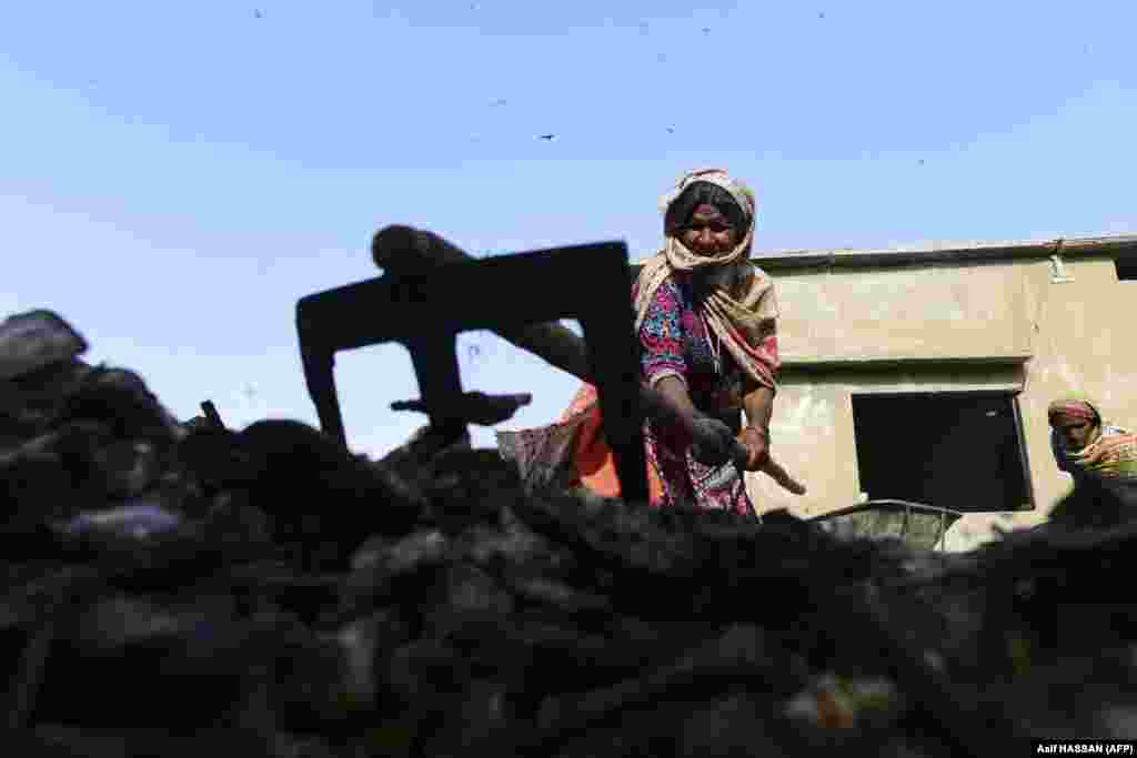 A Pakistani woman sorts waste at a local factory in Karachi.&nbsp;