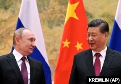 Russian President Vladimir Putin (left) and Chinese President Xi Jinping meet in Beijing on February 4.