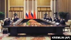 Chinese President Xi Jinping (fourth from right) and Russian President Vladimir Putin (fourth from left) attend a joint meeting in Beijing on February 4 where they declared a "no limits" partnership. 