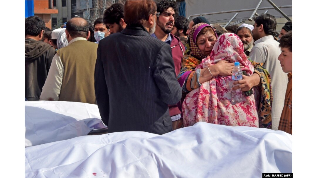 Relatives mourn the death of their loved ones outside a hospital following a bomb blast at a mosque in Peshawar on March 4.