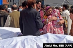 Relatives mourn the death of their loved ones outside a hospital following a bomb blast at a mosque in Peshawar on March 4.