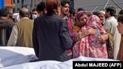 Family members mourn the death of their relatives outside a hospital following a bomb blast at a mosque in Peshawar on March 4.