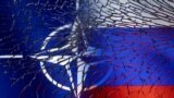 NATO and Russian flags are seen through broken glass in this illustration taken March 1, 2022.