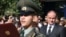 Armenia -- Defense Minister Seyran Ohanian (R) looks on as a military academy graduate takes an oath of allegience to the armed forces.