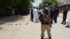 Pakistani security officials stand guard at a the scene of a blast in Ghotki, Sindh Province on June 19.
