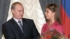 Russia -- President Vladimir Putin hands flowers to Alina Kabayeva, rhytmic gymnastics star and Olympic prize winner, after awarding her with an Order of Friendship during annual award ceremony in the Kremlin, 08Jun2001