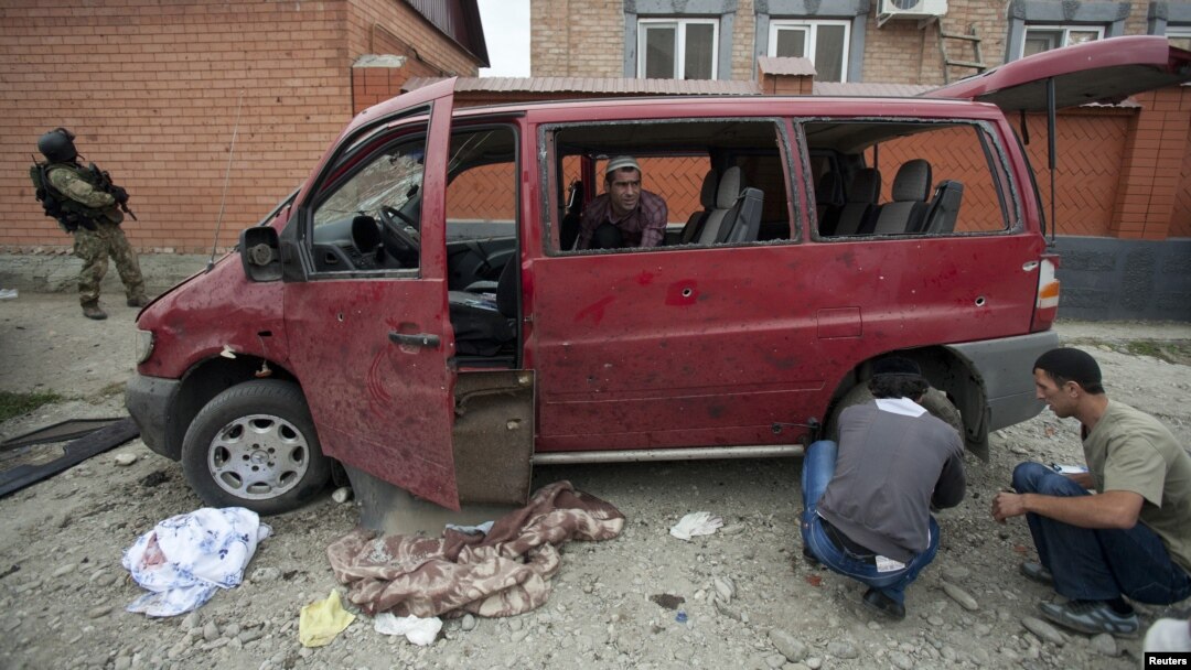 Investigators work at the site of a suicide bomb attack in the Malgobek Raion on August 19.