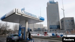 A Gazprom Neft gas station in Moscow with Gazprom headquarters in the background
