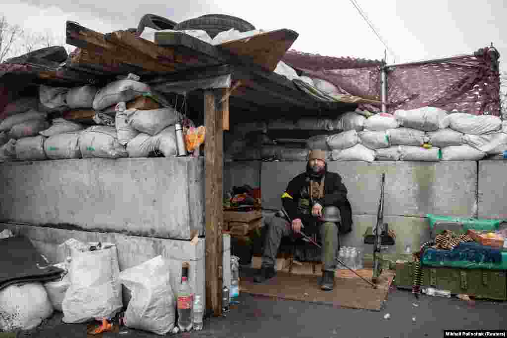 A member of Ukraine&#39;s Territorial Defence Forces is seen at a fortified checkpoint in Kyiv on March 4.&nbsp;