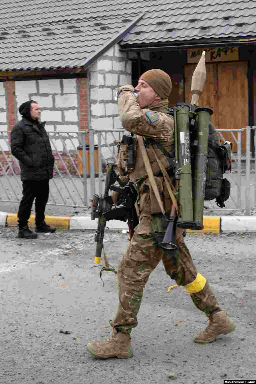 A heavily armed Ukrainian soldier on March 5 in Irpin, a northwestern suburb of Kyiv. Irpin was pounded by Russian air strikes and has been cut off from electricity, water, and heating for three days.