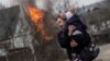 A man escapes with a child during heavy fighting in the town of Irpin, Ukraine, on March 6.