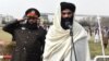 Taliban Interior Minister Sirajuddin Haqqani (right) speaks to new Afghan police recruits during a graduation ceremony at the police academy in Kabul on March 5.