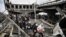 People cross a destroyed bridge as they evacuate the city of Irpin, northwest of Kyiv, during heavy shelling and bombing on March 5.