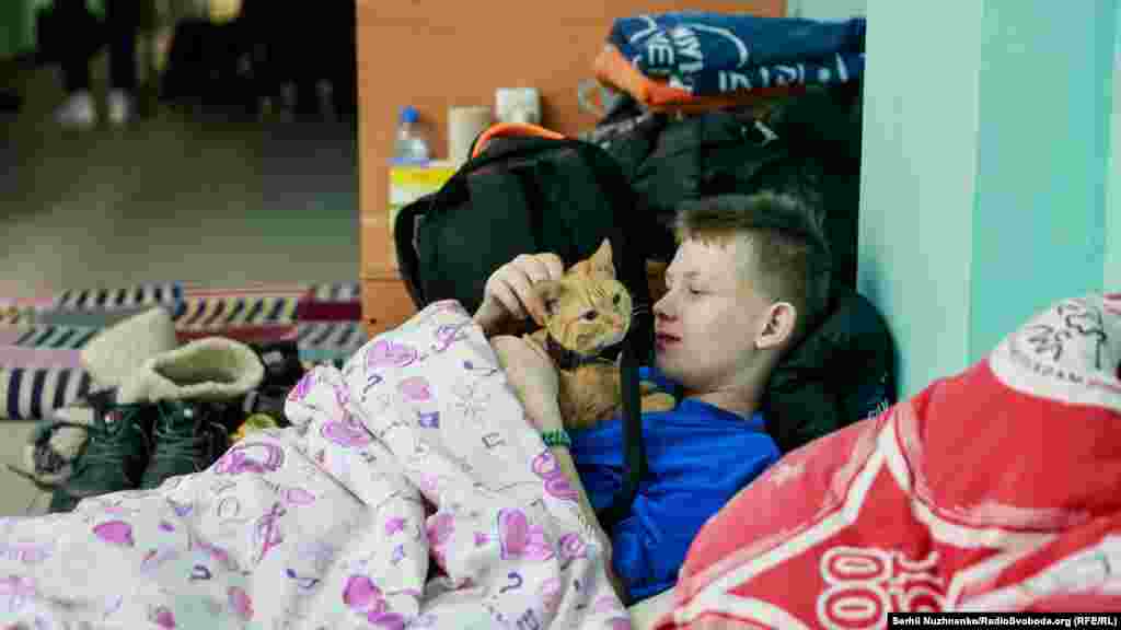 A child pets his cat in a bomb shelter near Kyiv, Ukraine, on March&nbsp; 6.&nbsp;